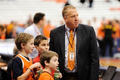 At a Syracuse basketball game (L to R), Pete Moore on the sidelines with stepsons Tyler Johnson and Leo Johnson and son Jack Moore.